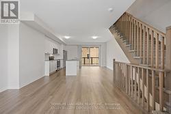 Living room to kitchen angled at stairs - 