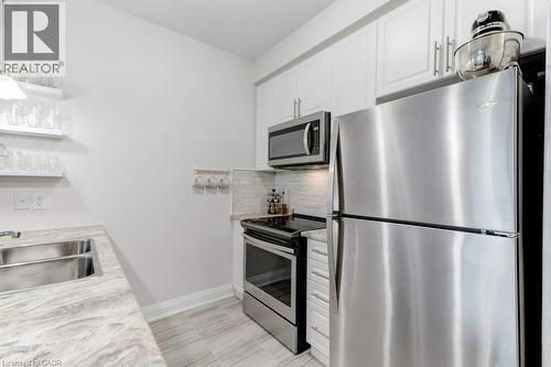 16 Concord Place Unit# 123, Grimsby, ON - Indoor Photo Showing Kitchen With Double Sink