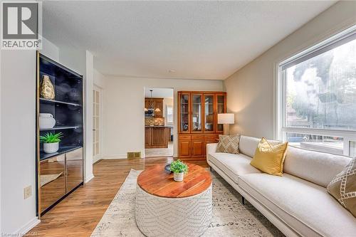 Bright living area featuring wood-finish flooring, a large window, and light-toned walls - 43 Niska Drive, Waterdown, ON - Indoor Photo Showing Living Room