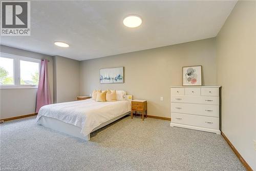 Spacious room featuring neutral-toned walls, light-colored carpeting, and a large window - 43 Niska Drive, Waterdown, ON - Indoor Photo Showing Bedroom