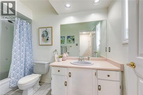 Full bathroom featuring a single vanity with a built-in sink, white cabinetry, and a large wall-mounted mirror - 43 Niska Drive, Waterdown, ON - Indoor Photo Showing Bathroom
