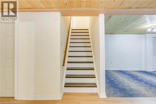 Staircase with wood treads and white risers, featuring a wood handrail - 43 Niska Drive, Waterdown, ON - Indoor Photo Showing Other Room