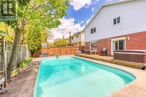 Private backyard oasis featuring a rectangular swimming pool with concrete surround - 43 Niska Drive, Waterdown, ON - Outdoor With In Ground Pool With Deck Patio Veranda With Backyard