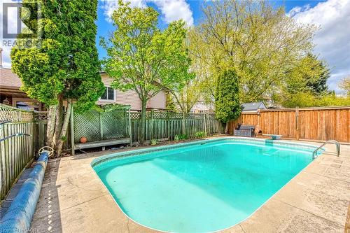 In-ground swimming pool with surrounding concrete patio - 43 Niska Drive, Waterdown, ON - Outdoor With In Ground Pool With Backyard