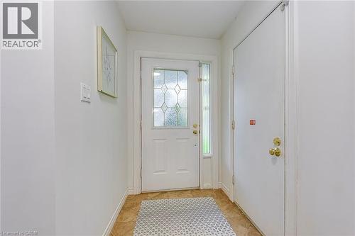 Entryway featuring a white door with decorative glass inserts, a full-length sidelight, and brass hardware - 43 Niska Drive, Waterdown, ON - Indoor Photo Showing Other Room