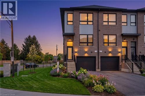 Modern townhome exterior featuring brick and panel siding - 720 Grey Street Unit# 34, Brantford, ON - Outdoor