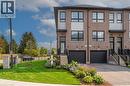 Modern townhome exterior featuring a brick and panel facade, black-framed windows, and a dedicated single-car garage - 720 Grey Street Unit# 34, Brantford, ON  - Outdoor With Facade 