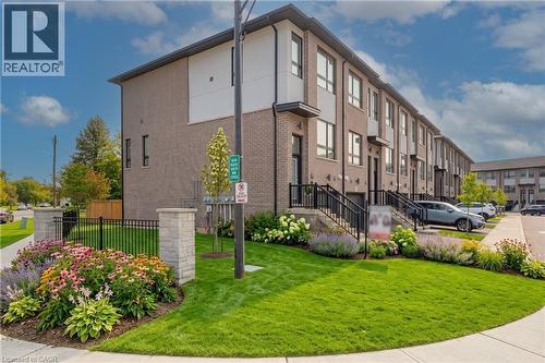 Modern townhome exterior with brick and paneling accents - 720 Grey Street Unit# 34, Brantford, ON - Outdoor