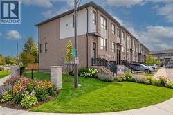 Modern townhome exterior with brick and paneling accents - 