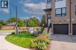 Modern brick townhouse with a black garage door and private entrance - 