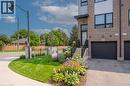 Modern brick townhouse with a black garage door and private entrance - 720 Grey Street Unit# 34, Brantford, ON  - Outdoor 