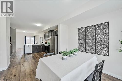 Open-concept dining area featuring wood-finish flooring, white walls, and recessed lighting - 720 Grey Street Unit# 34, Brantford, ON - Indoor Photo Showing Dining Room