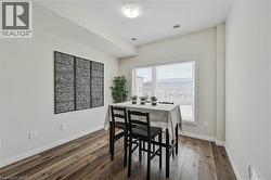 Dining area featuring wood-finish flooring, a large window with blinds, and recessed lighting - 