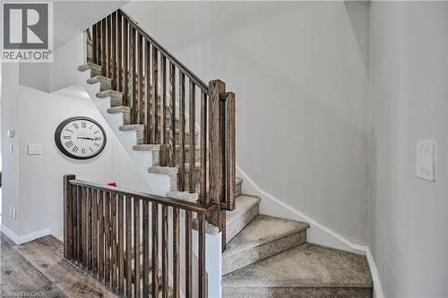 Carpeted staircase with dark wood-finish newel posts and spindles - 720 Grey Street Unit# 34, Brantford, ON - Indoor Photo Showing Other Room