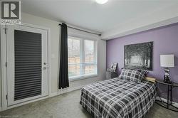 Carpeted room featuring a white door with integrated blinds, a window with horizontal blinds, and a light purple accent wall - 