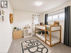 Bright room featuring light gray carpeting and white walls - 