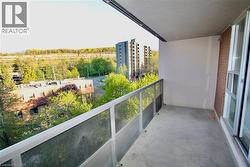 Private balcony featuring a concrete floor, glass and metal railing, and a sliding glass door entry - 