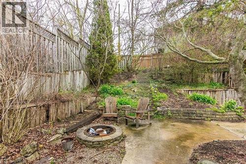 Patio with a firepit and steps to a play area - 1774 Old Mill Road, Kitchener, ON - Outdoor