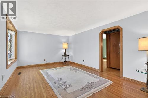 Hardwood flooring extends throughout this room, complemented by light-toned walls and crisp white ceilings - 525 East 16Th Street, Hamilton, ON - Indoor Photo Showing Other Room