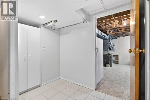Utility space featuring white cabinetry, recessed lighting, and tile flooring - 525 East 16Th Street, Hamilton, ON - Indoor Photo Showing Other Room