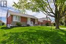 Brick and stone facade residence featuring a front lawn with a mature tree - 525 East 16Th Street, Hamilton, ON  - Outdoor 