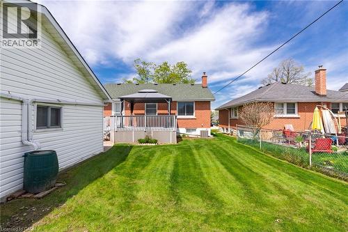 Expansive rear yard featuring a manicured lawn, an elevated deck with a gazebo, and a brick exterior - 525 East 16Th Street, Hamilton, ON - Outdoor With Deck Patio Veranda With Exterior