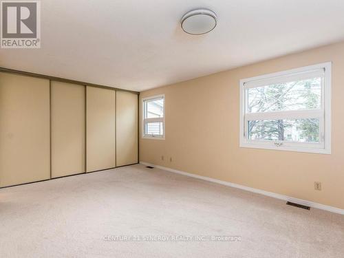 Primary Bedroom w/full wall of closet, new carpets - 80 - 22C Maple Ridge Crescent, Ottawa, ON - Indoor Photo Showing Other Room