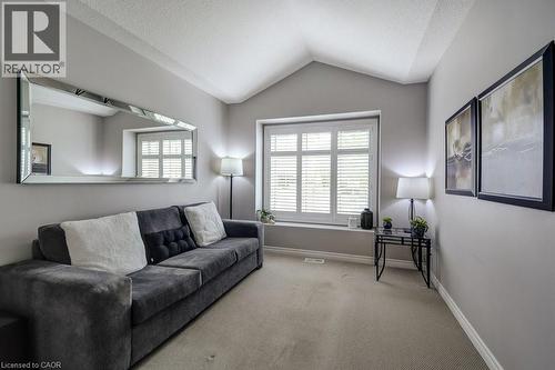 Interior room featuring a vaulted ceiling and window with plantation shutters - 605 Welland Avenue Unit# 21, St. Catharines, ON - Indoor Photo Showing Living Room