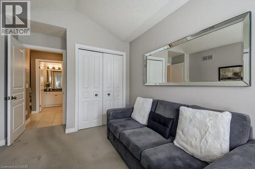 Vaulted ceiling room featuring light gray wall paint and gray carpet flooring - 605 Welland Avenue Unit# 21, St. Catharines, ON - Indoor