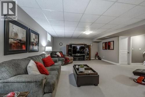 Spacious recreation room featuring light gray walls, plush carpeting, and a dropped ceiling with recessed lighting - 605 Welland Avenue Unit# 21, St. Catharines, ON - Indoor