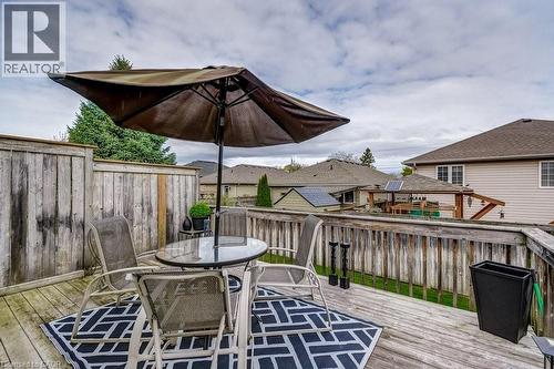 Outdoor wooden deck featuring a privacy fence, wood railing, and a black and white geometric pattern rug - 605 Welland Avenue Unit# 21, St. Catharines, ON - Outdoor With Deck Patio Veranda With Exterior