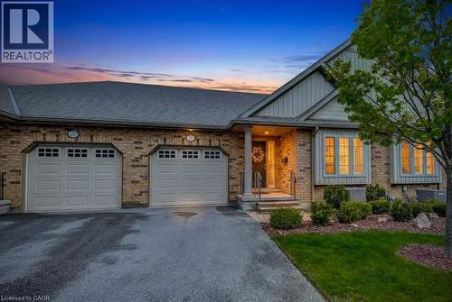 Brick exterior with a shingle roof and a two-car garage - 605 Welland Avenue Unit# 21, St. Catharines, ON - Outdoor With Facade