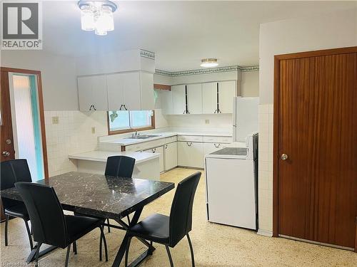 Open-concept kitchen with white cabinetry and a white tile backsplash - 157 Schweitzer Street, Kitchener, ON - Indoor