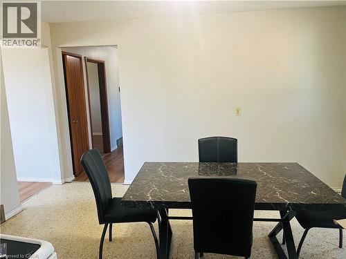Dining area featuring light-toned flooring, a light-colored wall, and a wide doorway - 157 Schweitzer Street, Kitchener, ON - Indoor Photo Showing Dining Room