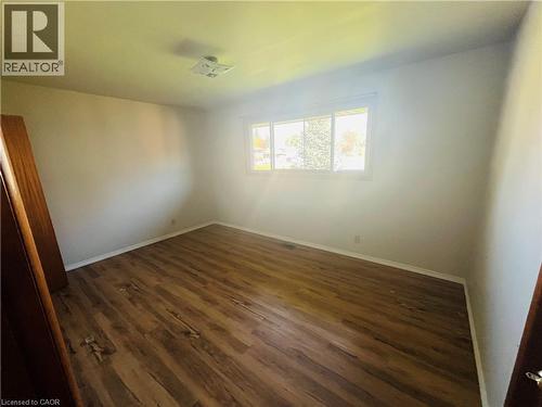 Room featuring wood-finish flooring, white baseboards, and neutral wall paint - 157 Schweitzer Street, Kitchener, ON - Indoor Photo Showing Other Room