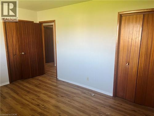 Interior space featuring wood-finish flooring, white baseboards, and light-toned walls - 157 Schweitzer Street, Kitchener, ON - Indoor Photo Showing Other Room
