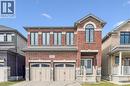 Brick facade residence featuring a two-car garage with arched panel doors - 628 Florencedale Crescent, Kitchener, ON 