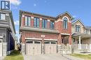 Brick and stone facade residence featuring a two-car garage with arched window inserts - 628 Florencedale Crescent, Kitchener, ON 