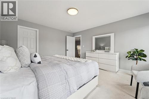 Light gray wall paint complemented by white trim and a neutral carpet - 628 Florencedale Crescent, Kitchener, ON 