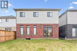 Rear elevation featuring red brick and light siding - 