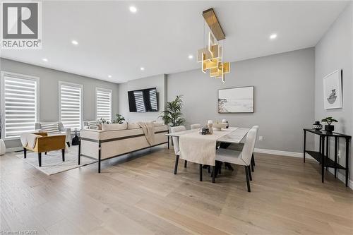 Open-concept living and dining area featuring light wood-finish flooring - 628 Florencedale Crescent, Kitchener, ON 