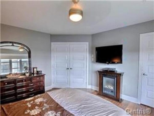 Master Bedroom - 205-65 Rue Des Manoirs, Charlemagne, QC - Indoor Photo Showing Bedroom With Fireplace