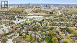 Expansive aerial view showcasing a residential area with varied housing styles and mature trees - 