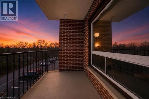 Private balcony with concrete flooring and dark metal railing - 303-4 Avalon Place, Kitchener, ON - Outdoor With Balcony With Exterior