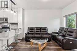 Living room with dark wood-style flooring - 