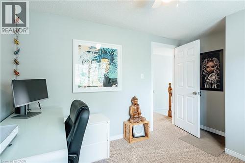 Light-colored walls complement the textured neutral-tone carpet flooring - 560 Penny Lane, Waterloo, ON 
