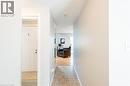 Hallway featuring neutral wall colors, textured ceiling, and tiled flooring - 560 Penny Lane, Waterloo, ON 