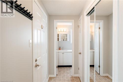 Inviting entryway featuring tile flooring and a bright, neutral color palette - 560 Penny Lane, Waterloo, ON 