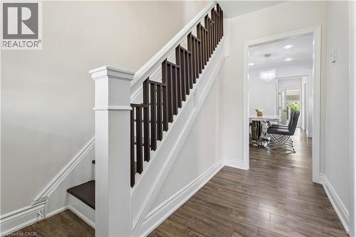 Interior staircase featuring a white newel post and dark wood balusters - 180 Campbell Avenue, Hamilton, ON - Indoor Photo Showing Other Room