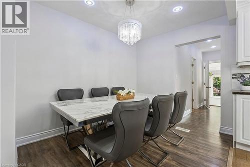 Dining area featuring a crystal chandelier, recessed lighting, and wood-finish flooring - 180 Campbell Avenue, Hamilton, ON - Indoor